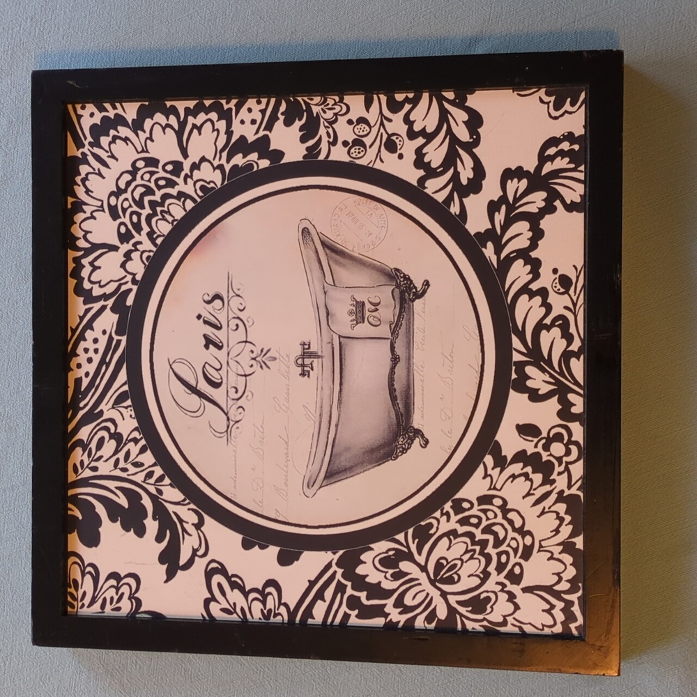 Black and cream bath tub with floral design border and black frame.